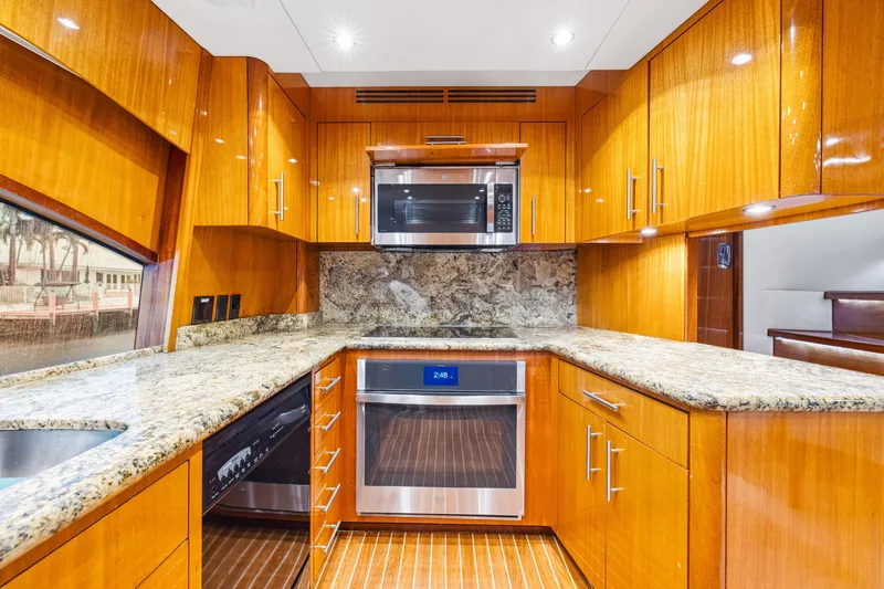 Slide: The Image of Luxurious kitchen in 2005 Hatteras 80 Motor Yacht with wood cabinetry and modern appliances. - 38