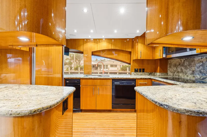 Slide: The Image of Luxurious kitchen interior of 2005 Hatteras 80 Motor Yacht with wood cabinetry and granite countertops. - 39