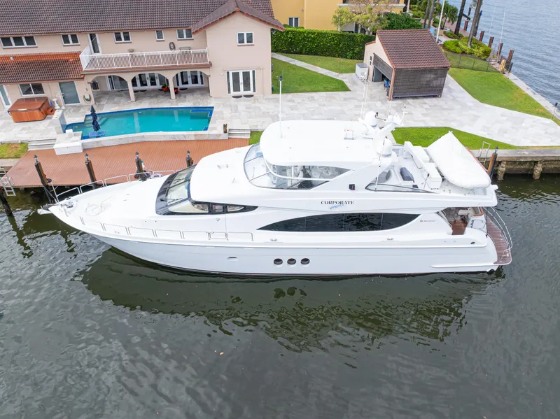 Slide: The Image of 2005 Hatteras 80 Motor Yacht docked near waterfront home with pool. - 4