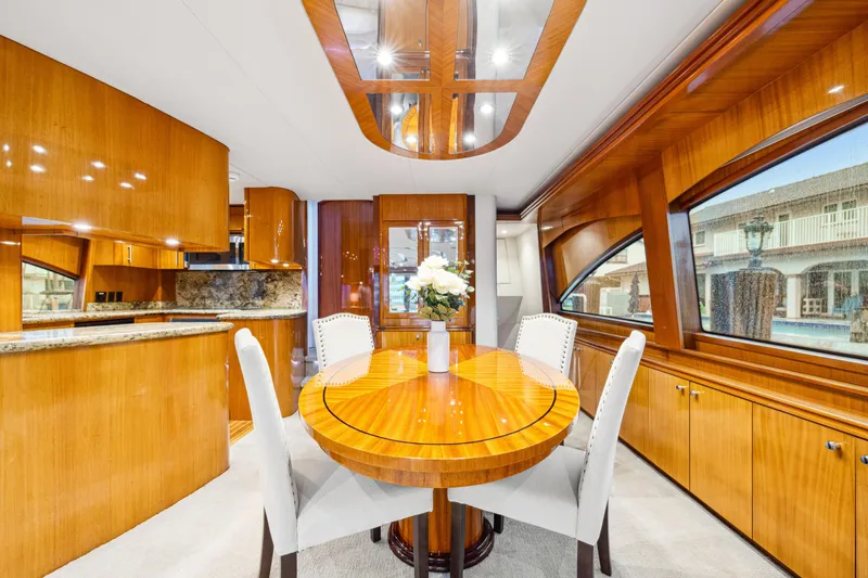 Slide: The Image of Luxurious interior of 2005 Hatteras 80 Motor Yacht with elegant dining area and wood finishes. - 40