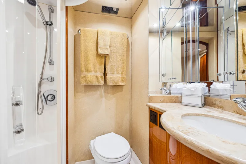 Slide: The Image of Luxurious bathroom in 2005 Hatteras 80 Motor Yacht with elegant fixtures and mirrored cabinets. - 48