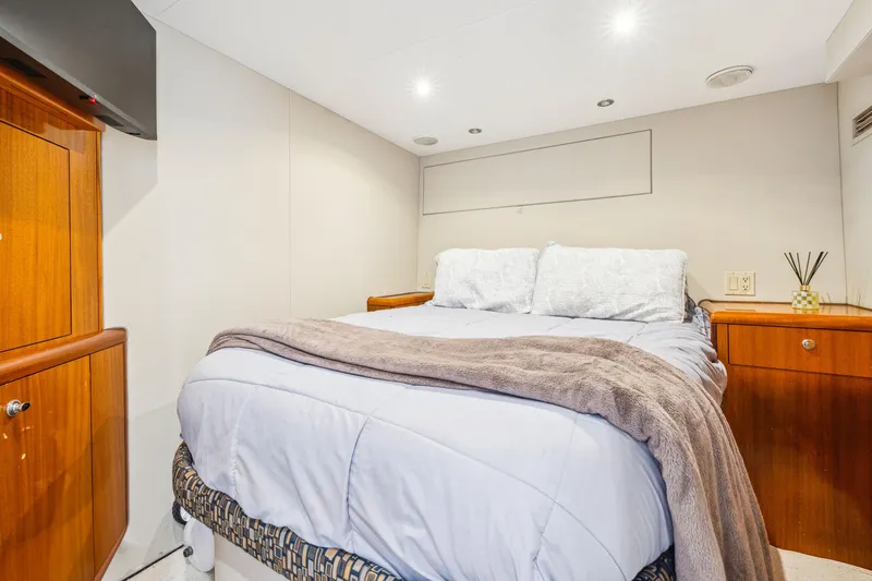 Slide: The Image of Cozy bedroom in 2005 Hatteras 80 Motor Yacht with elegant wood cabinetry. - 49