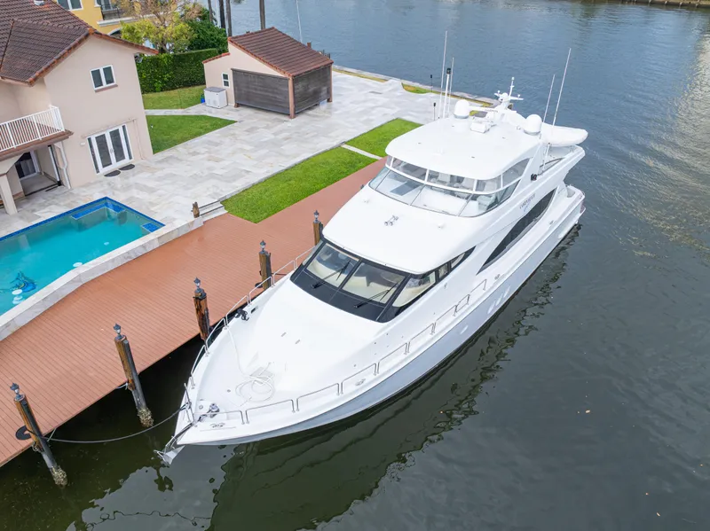 Slide: The Image of 2005 Hatteras 80 Motor Yacht docked by waterfront home with pool. - 5