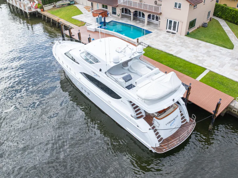 Slide: The Image of 2005 Hatteras 80 Motor Yacht docked by waterfront home with pool. - 6