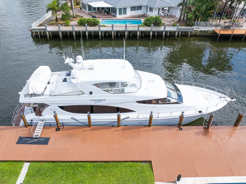 Slide: The Image of 2005 Hatteras 80 Motor Yacht docked by waterfront property. - 8