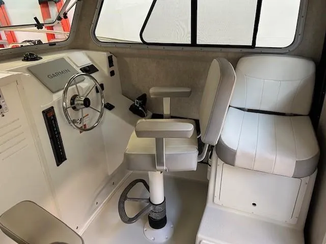 Slide: The Image of Interior of 2022 Parker 2520 XLD Sport Cabin with steering wheel and seating. - 11