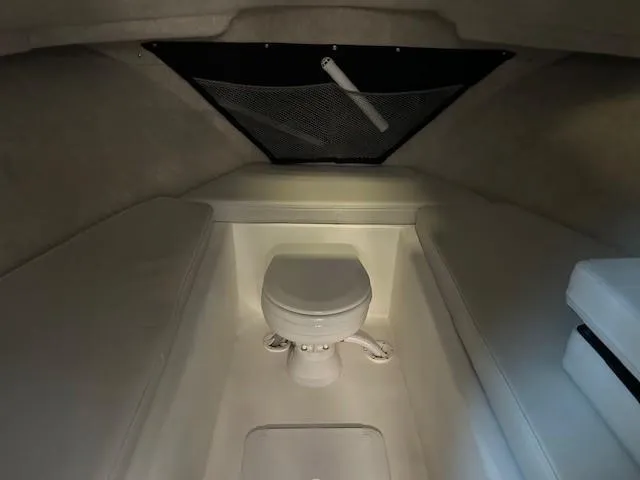 Slide: The Image of 2022 Parker 2520 XLD Sport Cabin interior with compact marine toilet. - 14