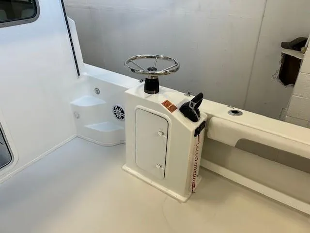 Slide: The Image of 2022 Parker 2520 XLD Sport Cabin boat interior with steering wheel and control panel. - 17