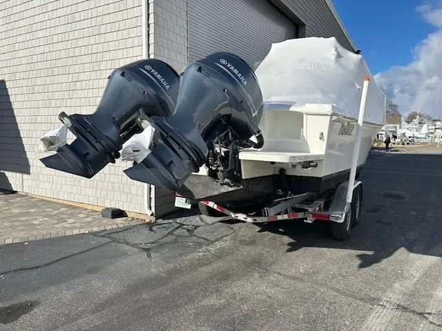 Slide: The Image of 2022 Parker 2520 XLD Sport Cabin boat with twin Yamaha outboard motors on a trailer. - 22