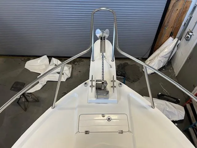 Slide: The Image of 2022 Parker 2520 XLD Sport Cabin boat bow with anchor and chain in a garage. - 5