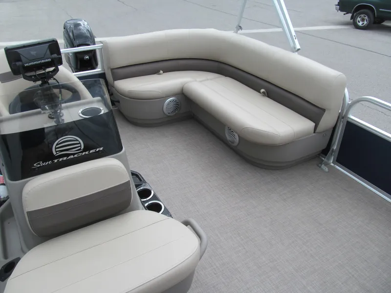 Slide: The Image of 2023 Sun Tracker Bass Buggy 16 XL Select pontoon boat interior with beige seating and console. - 11