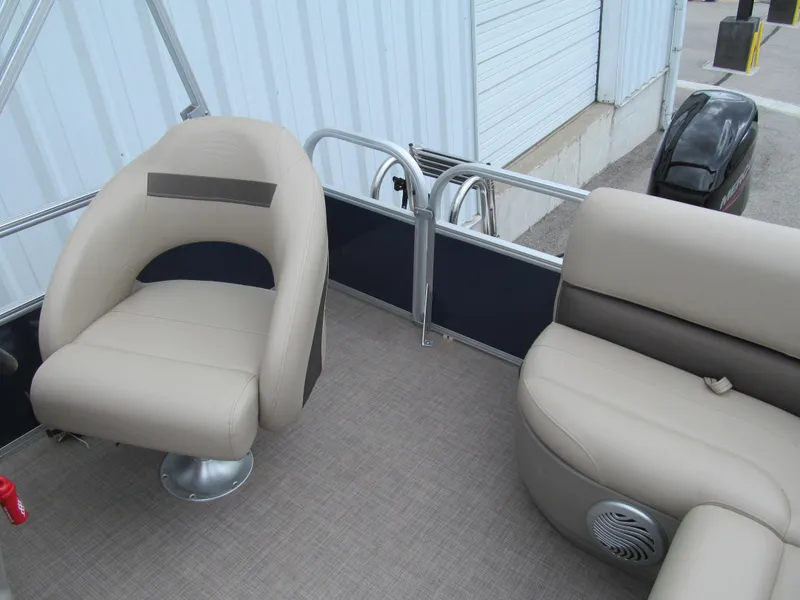 Slide: The Image of 2023 Sun Tracker Bass Buggy 16 XL Select pontoon boat interior with beige seating. - 12