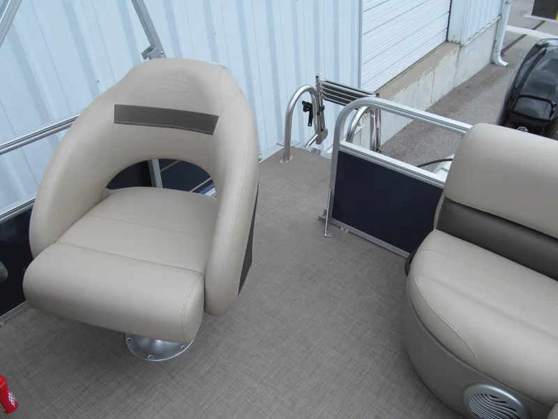 Slide: The Image of 2023 Sun Tracker Bass Buggy 16 XL Select boat interior with beige seating and railing. - 13