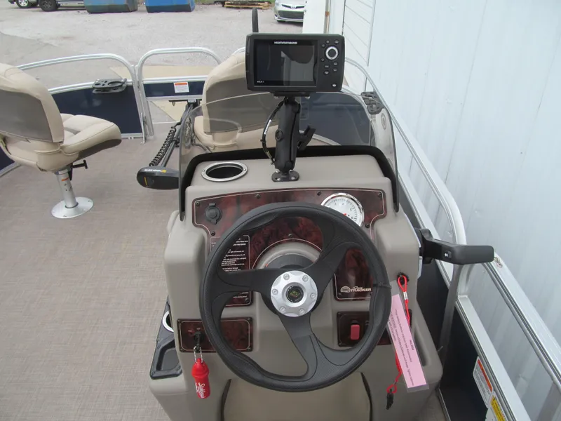 Slide: The Image of 2023 Sun Tracker Bass Buggy 16 XL Select boat dashboard with steering wheel and navigation system. - 6