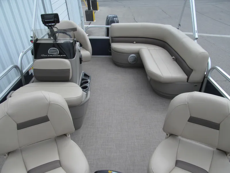 Slide: The Image of 2023 Sun Tracker Bass Buggy 16 XL Select pontoon boat interior with beige seating. - 9