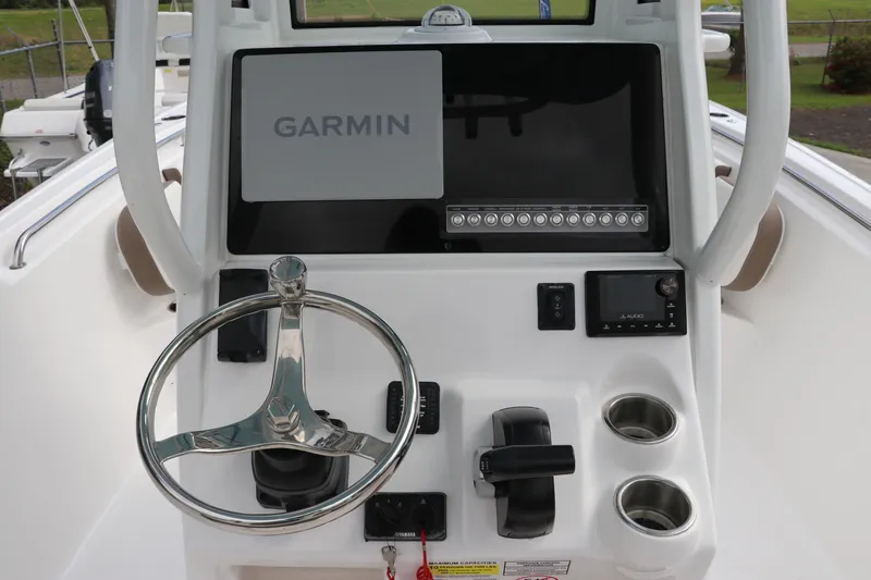 Slide: The Image of 2024 Tidewater 232 CC Adventure boat console with Garmin display and steering wheel. - 10