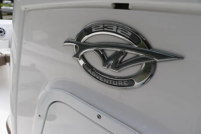 Slide: The Image of 2024 Tidewater 232 CC Adventure boat emblem on white surface. - 11