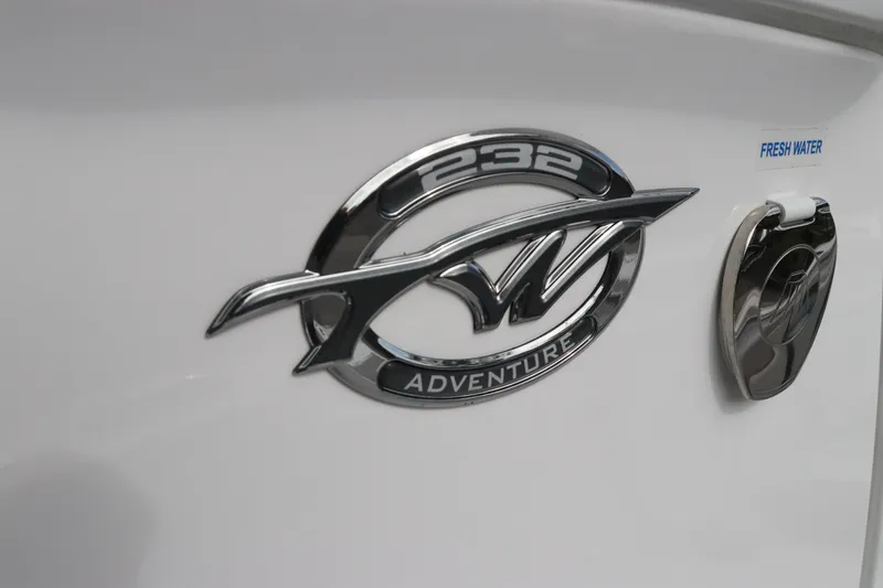 Slide: The Image of 2024 Tidewater 232 CC Adventure boat emblem on white surface. - 12
