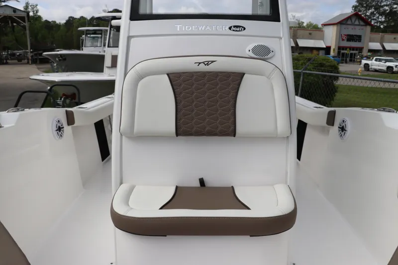 Slide: The Image of 2024 Tidewater 232 CC Adventure boat interior with cushioned seating and modern design. - 15