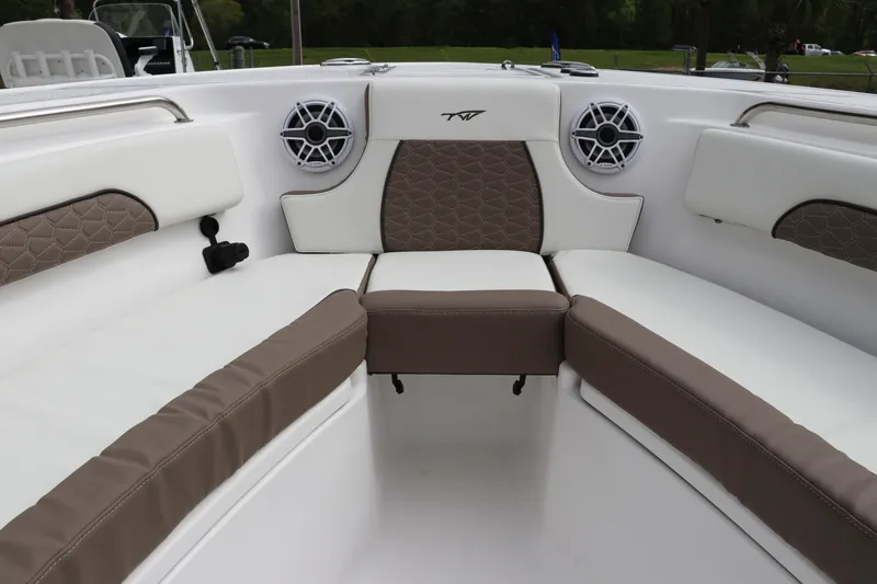 Slide: The Image of 2024 Tidewater 232 CC Adventure boat interior with cushioned seating and speakers. - 16