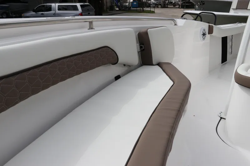 Slide: The Image of 2024 Tidewater 232 CC Adventure boat interior with cushioned seating. - 18