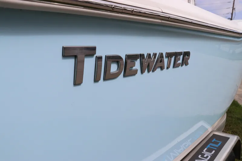 Slide: The Image of 2024 Tidewater 232 CC Adventure boat with sleek blue exterior and bold logo. - 3