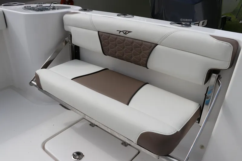 Slide: The Image of 2024 Tidewater 232 CC Adventure boat seat, white and brown upholstery, sleek design. - 4