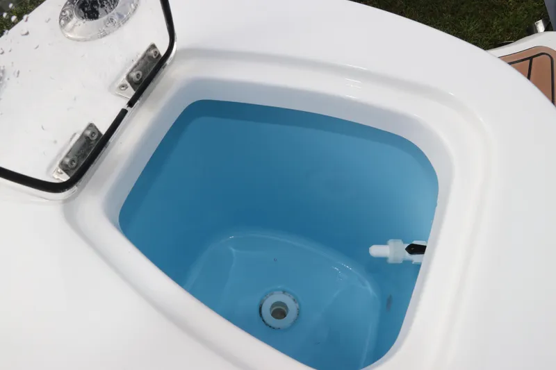 Slide: The Image of Livewell of 2024 Tidewater 232 CC Adventure boat, featuring a blue interior. - 5