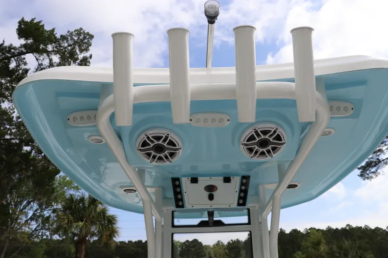 Slide: The Image of 2024 Tidewater 232 CC Adventure boat with rod holders and speakers on the T-top. - 7