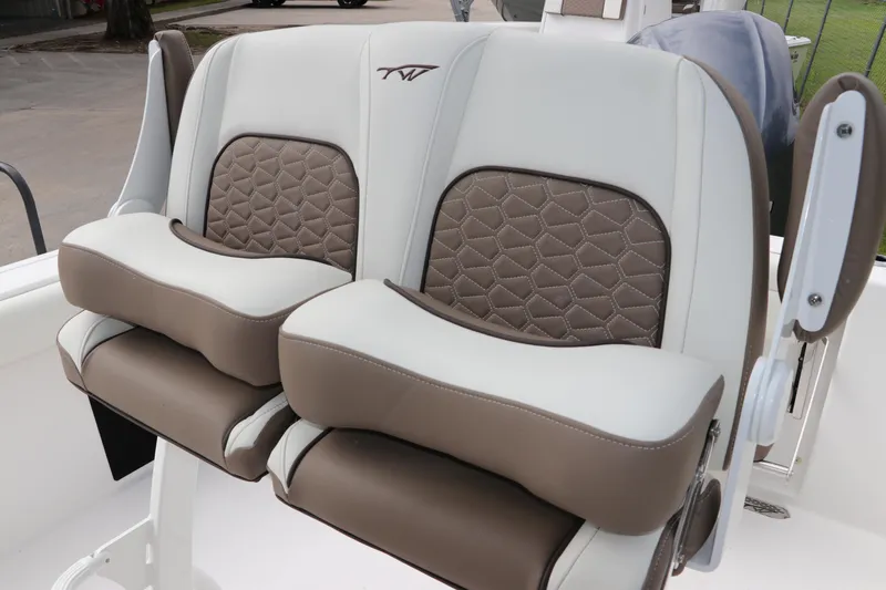 Slide: The Image of 2024 Tidewater 232 CC Adventure boat seats with brown and white cushioned design. - 8