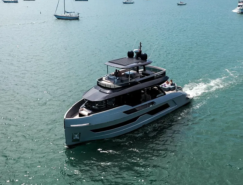 Slide: The Image of Modern 2021 Explorer 62 yacht cruising on a serene ocean with sailboats in the background. - 1