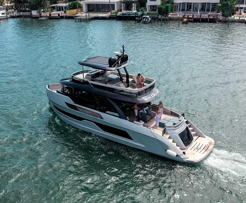 Slide: The Image of 2021 Explorer 62 yacht cruising on a sunny day with people on deck. - 2