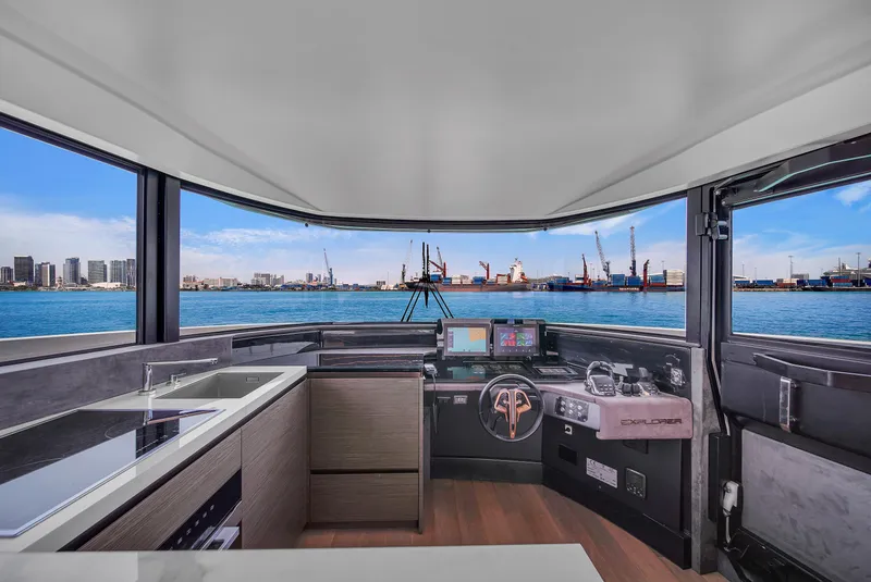 Slide: The Image of Modern Explorer 62 yacht interior with panoramic windows, sleek kitchen, and advanced navigation system, 2021 model. - 25