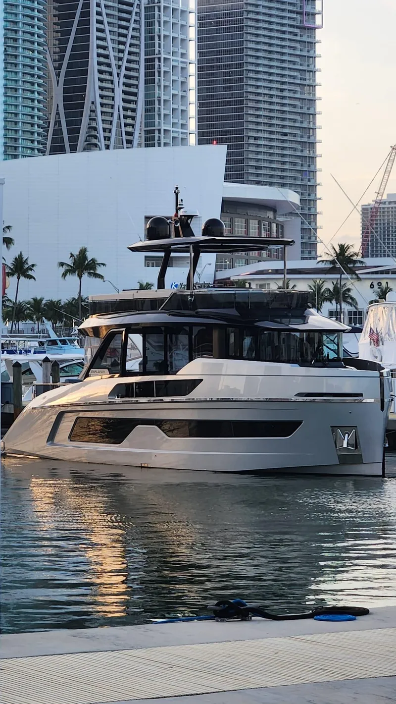 Slide: The Image of 2021 Explorer 62 yacht docked in a modern marina with cityscape background. - 3