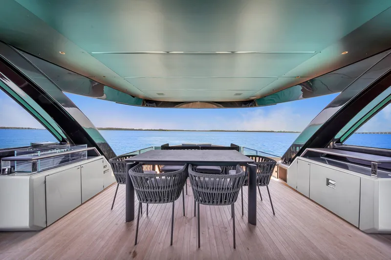 Slide: The Image of Luxurious Explorer 62 yacht deck with dining area, overlooking serene ocean view, 2021 model. - 34