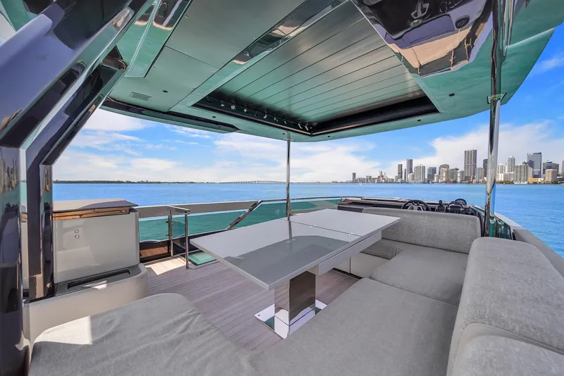 Slide: The Image of Luxurious 2021 Explorer 62 yacht interior with city skyline view, featuring modern seating and table. - 48