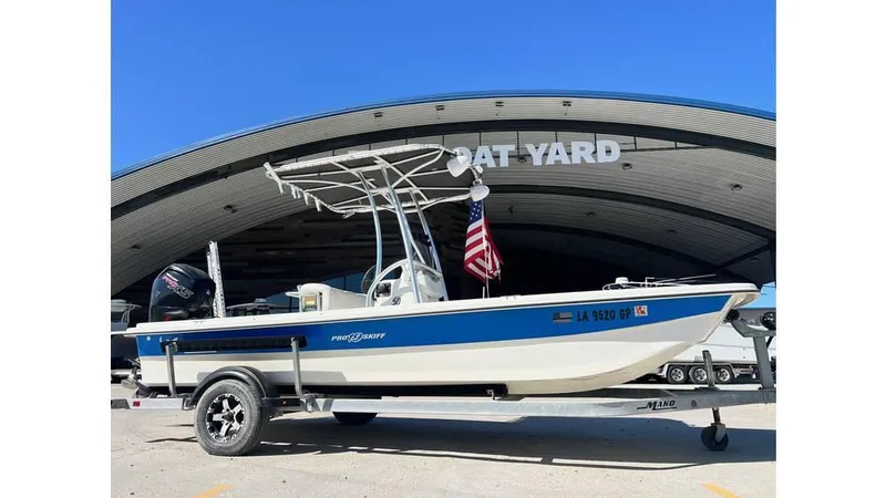 Slide: The Image of 2018 Mako Pro Skiff 19 CC boat on trailer, parked at boat yard. - 1