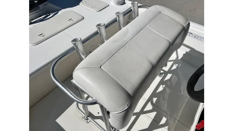 Slide: The Image of 2018 Mako Pro Skiff 19 CC boat seat with rod holders and white upholstery. - 3