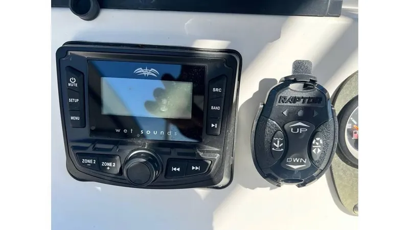 Slide: The Image of 2018 Mako Pro Skiff 19 CC audio controls and Raptor remote on dashboard. - 5
