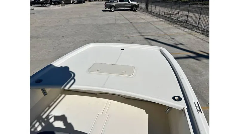 Slide: The Image of 2018 Mako Pro Skiff 19 CC boat on a concrete surface, viewed from the bow. - 7