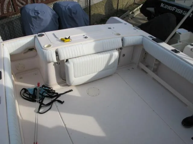 Slide: The Image of 2005 Grady-White 282 Sailfish boat interior with white seating and fishing gear. - 13