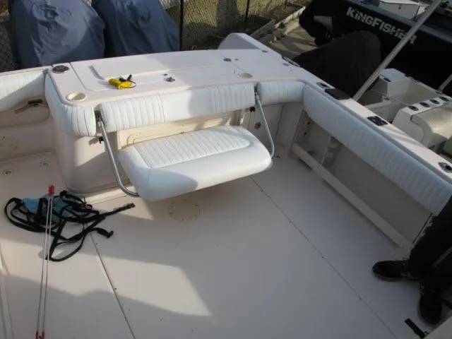Slide: The Image of 2005 Grady-White 282 Sailfish boat interior with foldable seating and fishing gear. - 14