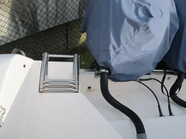 Slide: The Image of 2005 Grady-White 282 Sailfish boat with covered engines and metal ladder. - 17