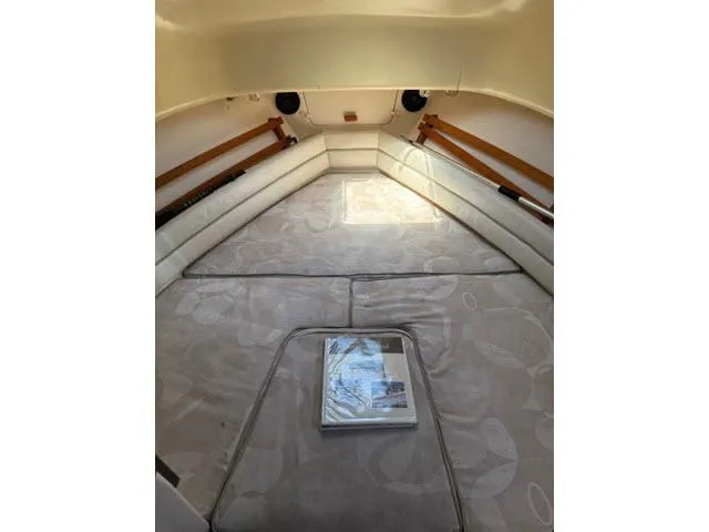 Slide: The Image of 2005 Grady-White 282 Sailfish cabin interior with cushioned seating and wooden accents. - 31