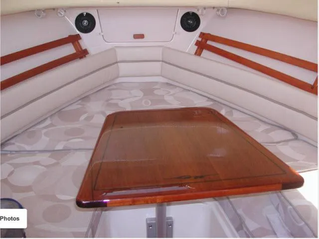 Slide: The Image of Interior of 2005 Grady-White 282 Sailfish boat with wooden table and cushioned seating. - 33