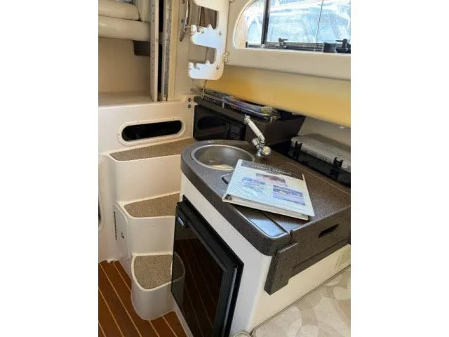 Slide: The Image of 2005 Grady-White 282 Sailfish boat interior with kitchenette and steps. - 37