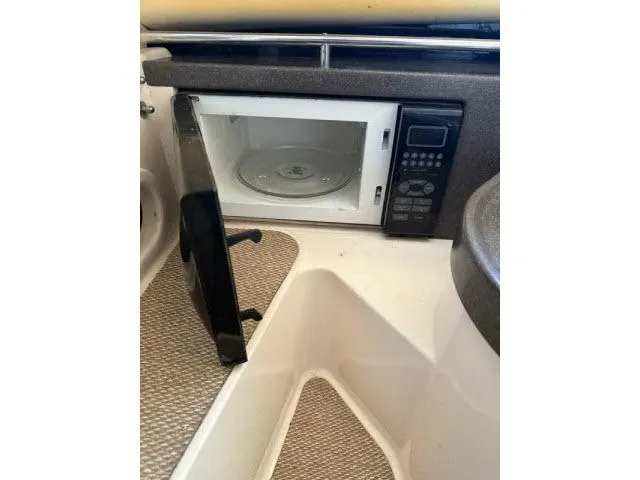 Slide: The Image of Microwave inside 2005 Grady-White 282 Sailfish boat cabin, door open, beige interior. - 39