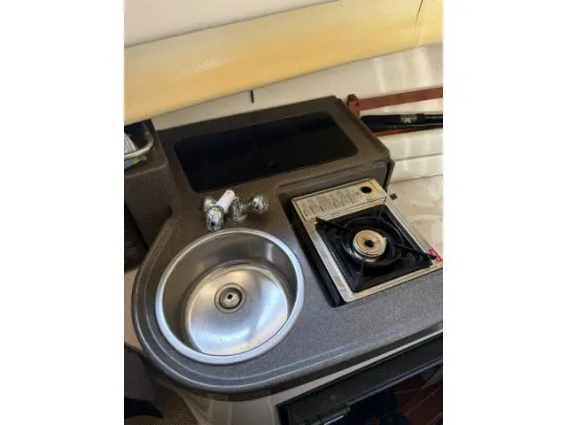 Slide: The Image of 2005 Grady-White 282 Sailfish boat galley with sink and stove. - 42