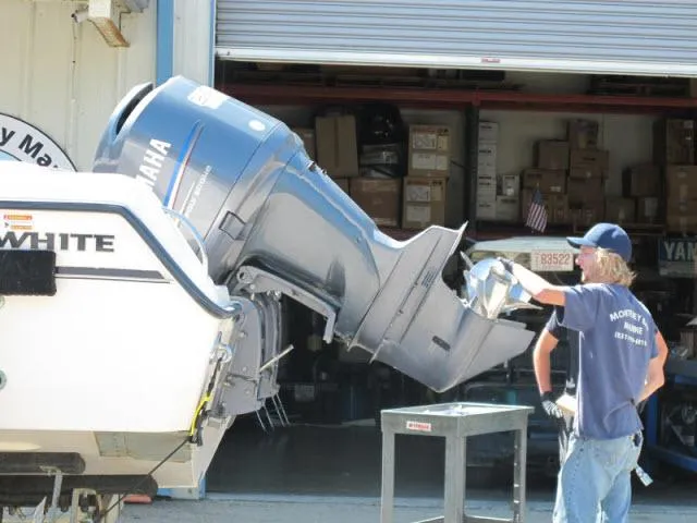 Slide: The Image of 2005 Grady-White 282 Sailfish with Yamaha outboard motor being serviced at a workshop. - 48