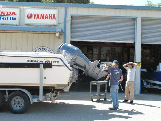 Slide: The Image of 2005 Grady-White 282 Sailfish boat at Yamaha service center with two people nearby. - 49